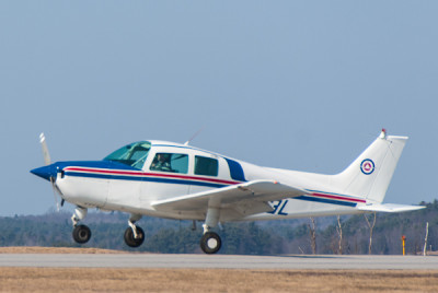 A training airplane lifts off of Runway 26 for a lesson with a flight student.